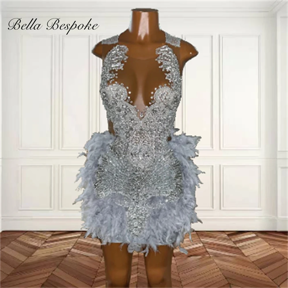 Silver prom dresses with beads, crystals, feathers, and custom back design